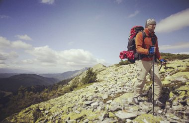 Bir sırt çantası ile Dağları yürüyen adam turizm.