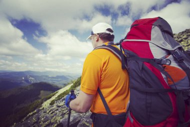 Bir sırt çantası ile Dağları yürüyen adam turizm.