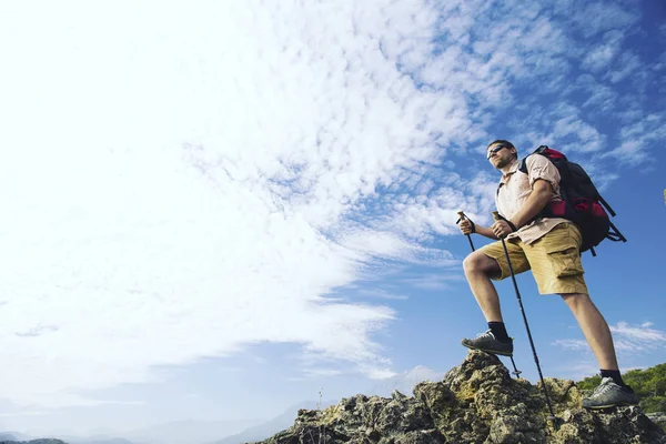 Man tourist walking the mountains with a backpack. — Stock Photo, Image