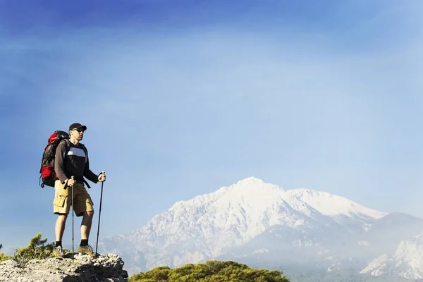 Bir sırt çantası ile Dağları yürüyen adam turizm. — Stok fotoğraf