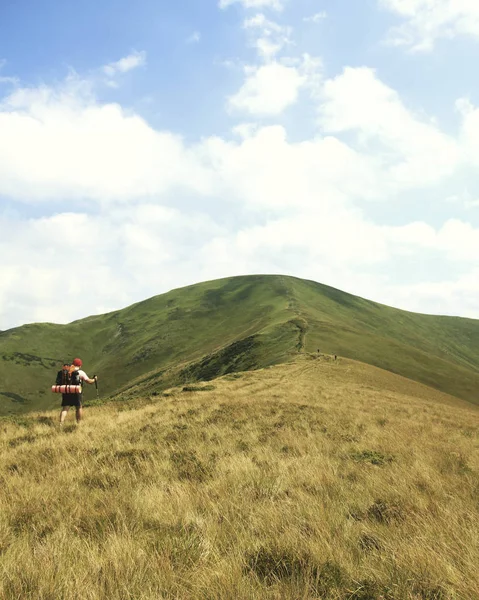 Man tourist walking the mountains with a backpack.