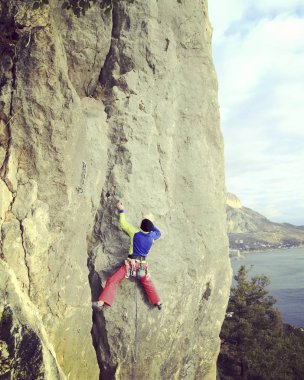 Arka planda geniş Vadisi ile kireçtaşı duvara tırmanma sallamak Climber.Young adam