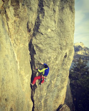 Arka planda geniş Vadisi ile kireçtaşı duvara tırmanma sallamak Climber.Young adam