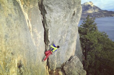 Arka planda geniş Vadisi ile kireçtaşı duvara tırmanma sallamak Climber.Young adam