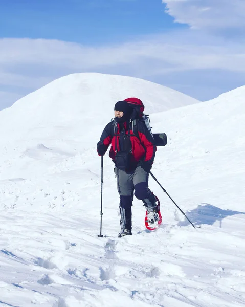 冬季徒步旅行。在山里徒步旅行带着背包和帐篷雪的冬天. — 图库照片