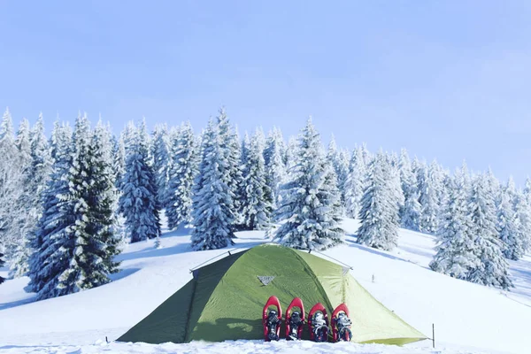 Winter hiking.Winter hiking in the mountains on snowshoes with a backpack and tent.