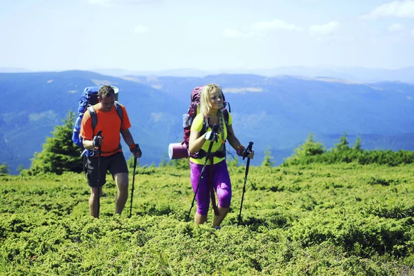 Summer hiking in the mountains with a backpack and tent. — Stock Photo, Image