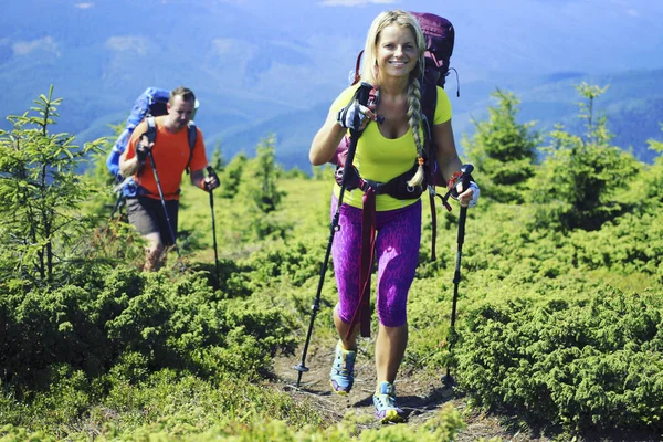 Summer hiking in the mountains with a backpack and tent. — Stock Photo, Image