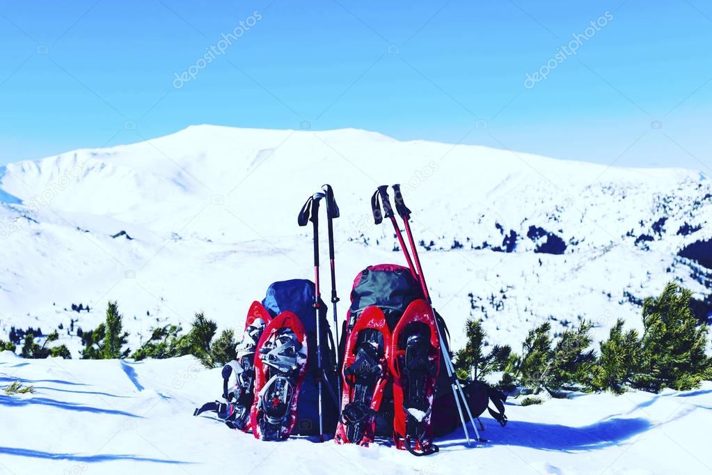 Winter hiking in the mountains on snowshoes with a backpack and 