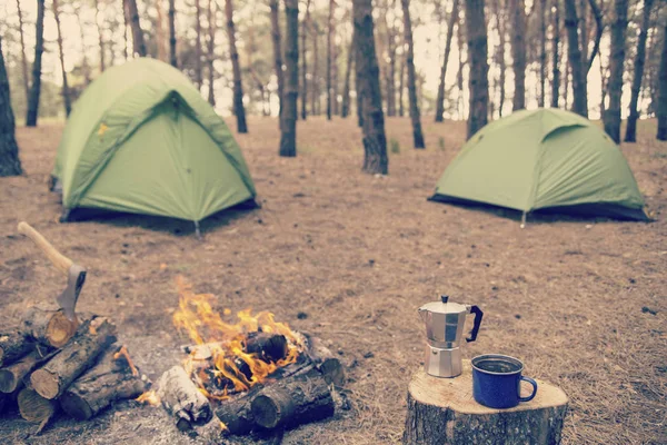 Camping in the forest. Preparation of breakfast at the stake.