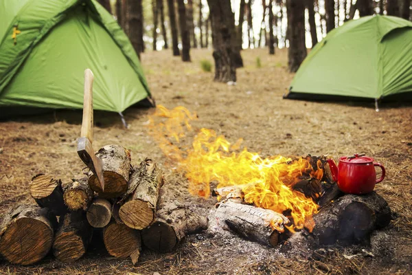 Camping in the forest. Preparation of breakfast at the stake.