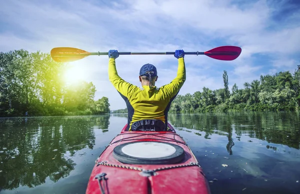 Un hombre balsa en un kayak en el río en un día soleado . —  Fotos de Stock