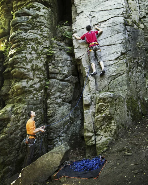 Ein junger Mann klettert in eine Schlucht. — Stockfoto