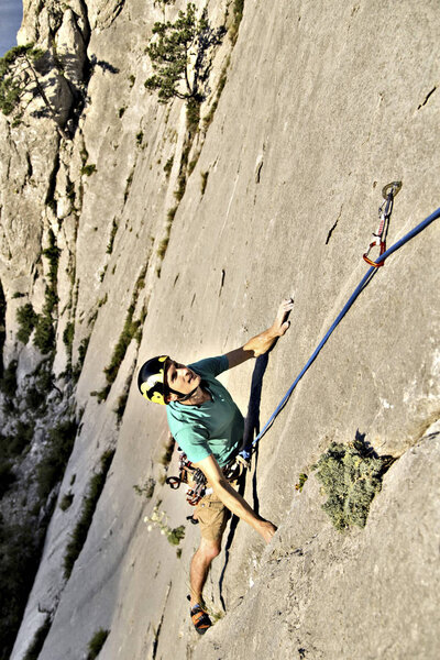 Rock climber reaching for his next hand hold, Joshua Tree Nation