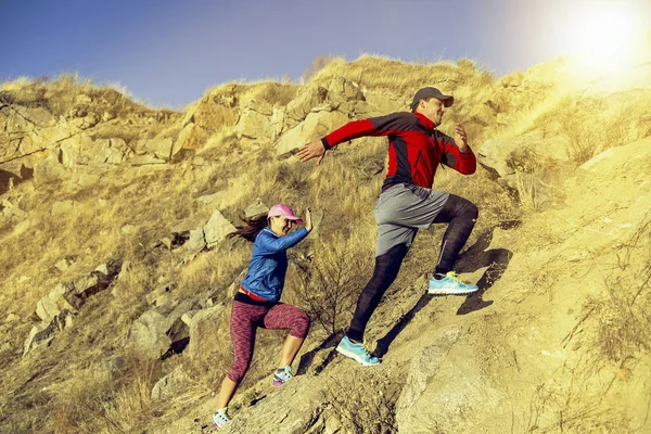 Trailrunning-Paar rast auf Bergpfad in Vulkangestein — Stockfoto