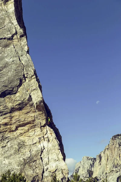 İki dağcı uçurumun tepesine tırmanmaya yapmak. — Stok fotoğraf