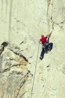 Dağcı dağın zirvesine tırmanıyor.