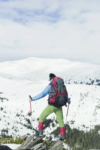 男は冬の山に登る. — ストック写真