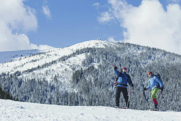 Senderismo de invierno en las montañas. Dos hombres hacen un ascenso a la — Foto de Stock