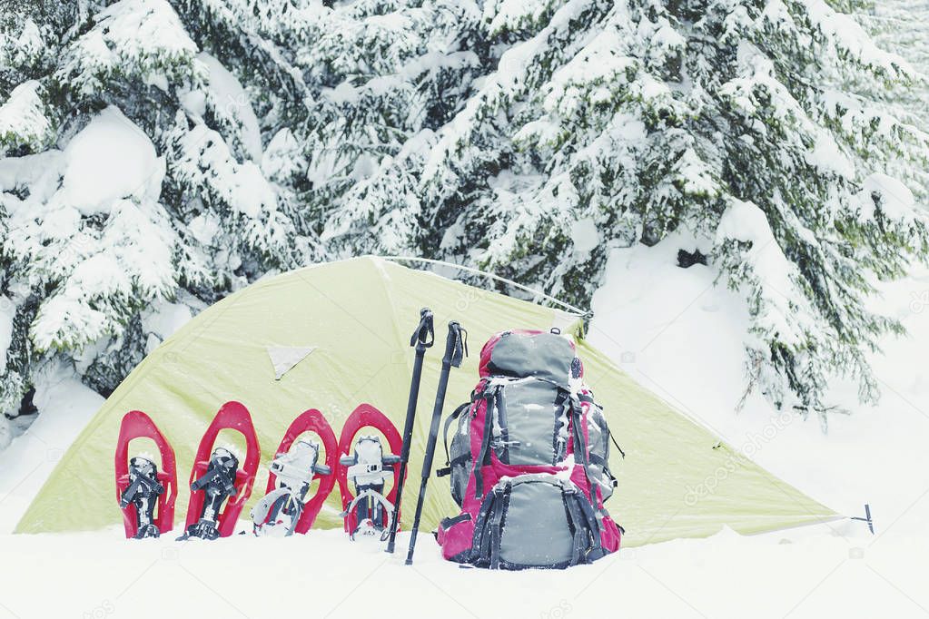 Winter trekking in the mountains. The tent stands on the mountai
