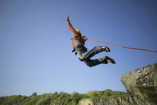 Un uomo sta saltando in un canyon . — Foto Stock