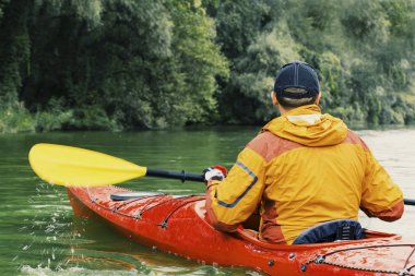Kano. Bir adam nehir boyunca kürek.