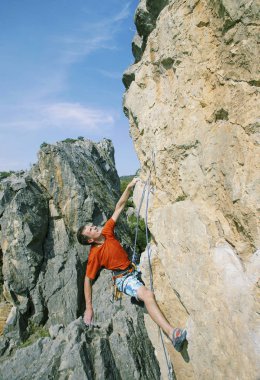Kaya tırmanışı. Bir adam kaya tırmanıyor.