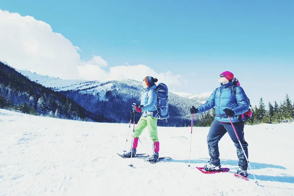 Winter hiking in the mountains on snowshoes with a backpack and — Stock Photo, Image