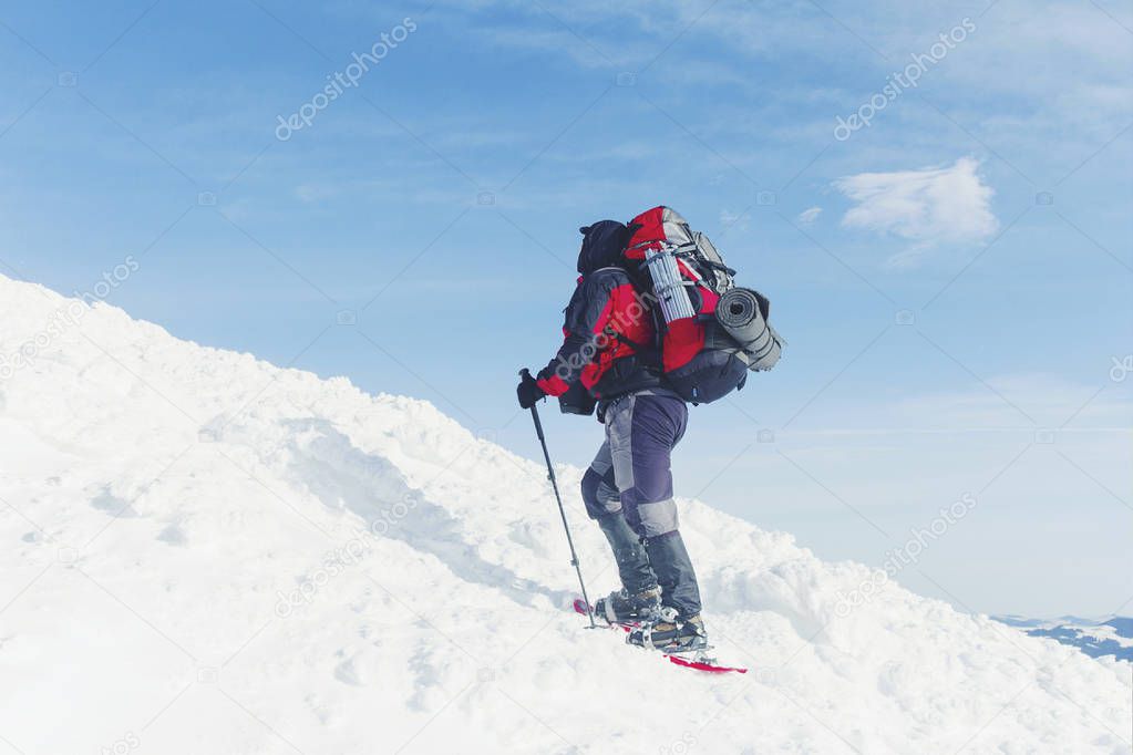 Snowshoe walker running in powder snow with beautiful sunrise li