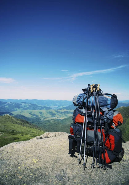 バックパックの山の上に立っています。. — ストック写真