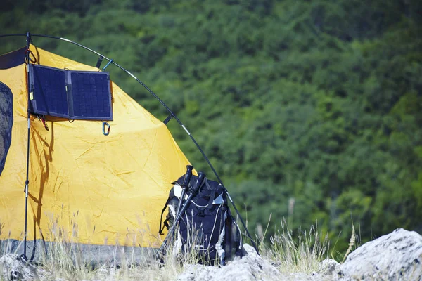 La tienda está en la cima de la montaña. El panel solar cuelga de la —  Fotos de Stock