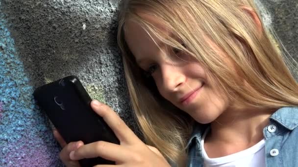 Ragazzo che utilizza Smartphone, Bambino che gioca su Smart Phone, Ragazza all'aperto nel parco — Video Stock