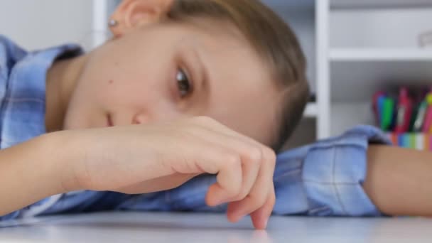 Trauriges Kind, gelangweiltes Mädchen, das mit den Fingern am Schreibtisch spielt, gestresstes unglückliches Kind, das nicht studiert — Stockvideo