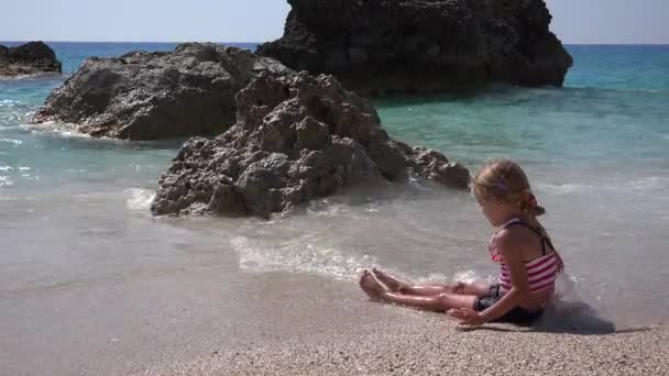 4k Kid Playing in Waves on Beach, Happy Child on Tropical Exotic Coastline, Girl Plays at Seaside — стокове відео