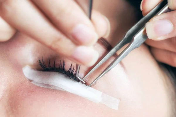 Beautician making artificial lashes