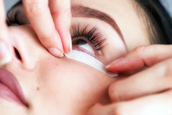 Beautician making artificial lashes