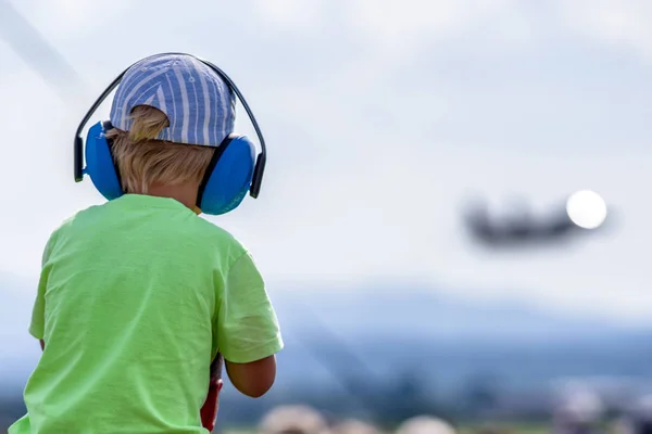 Child with hearing protections