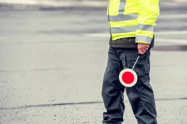 Cop in reflective vest with stop sign — 스톡 사진