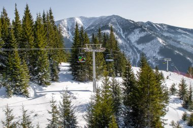Ski lift chair with skiers in resort Chopok Juh at Low Tatras mo
