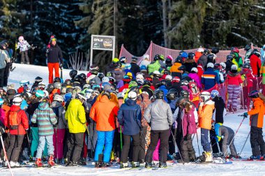 Many skiers wainting for ski lift on slope