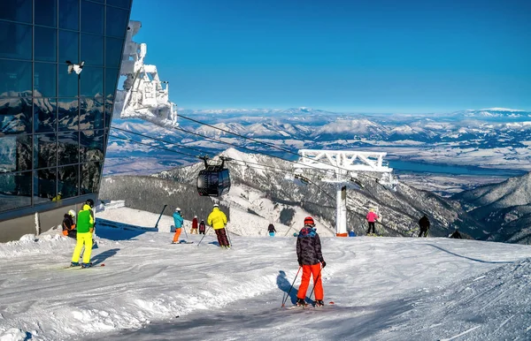 Skiers on slope at ski resort Jasna in Low Tatras mountains at S — ストック写真