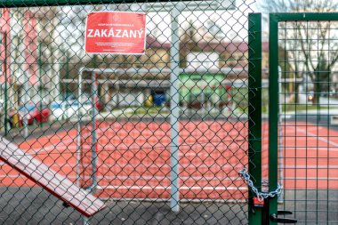 RUZOMBEROK, SLOVAKIA - APRIL 3, 2020: Closed basketball and football playground in centre of city due Coronavirus COVID-19 clipart