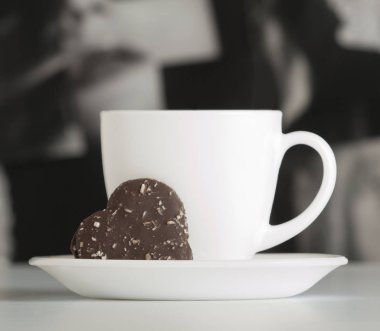 Chocolate cookies in the shape of heart on a background with a cup of coffee. Valentine's Day