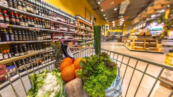 Supermarket cart filled  with healthy products — Stock Photo, Image