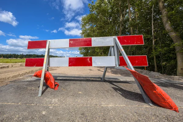 Red and white roadblock in perpective — Stock Photo, Image