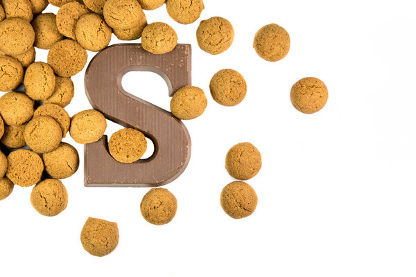 Handful of thrown Pepernoten cookies with chocolate letter