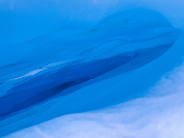 Blue ice hole background consisting of snow and light