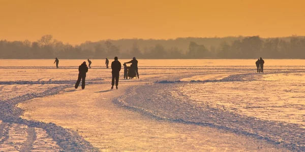 Holländische Eisläufer unter untergehender Sonne — Stockfoto