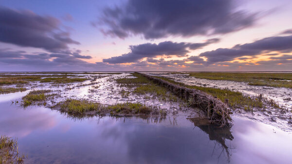 Закат над приливным болотом в Ваттовом море
