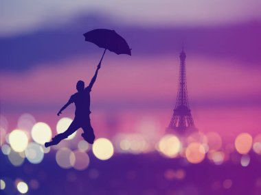 Arka plan: gece Paris, Fransa, Eyfel Kulesi ile üzerinde uçan şemsiye tutan bir adam silüeti